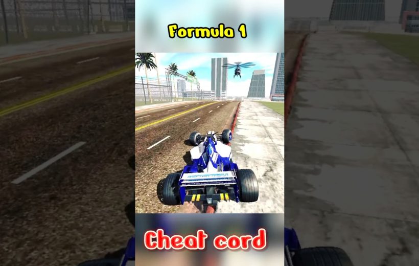 Blue Formula 1 car driving on city street with helicopter overhead and sidewalk nearby