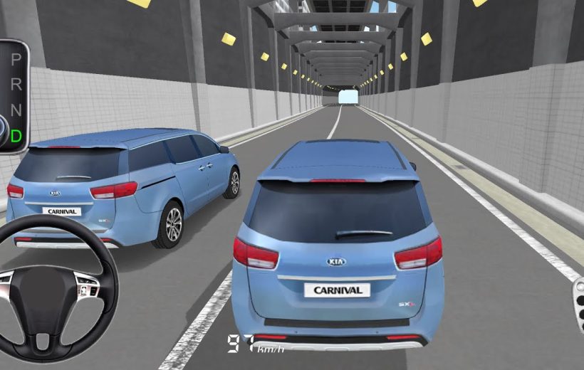 Two blue Kia Carnival minivans driving through a long lit tunnel, rear view visible