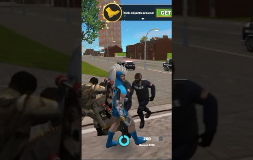 Video game character in blue costume fighting police officers on a city sidewalk