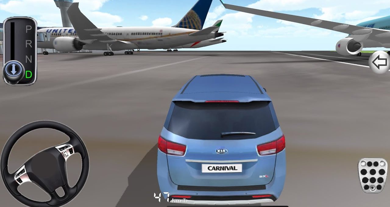 Blue Kia Carnival driving on an airport runway past parked commercial airplanes