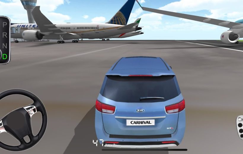 Blue Kia Carnival driving on an airport runway past parked commercial airplanes