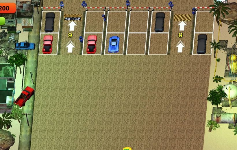 Top-down view of a parking lot with parked cars and surrounding industrial buildings