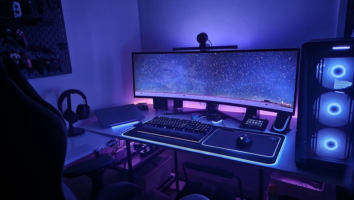 Gaming PC setup with ultrawide monitor, RGB lighting, mechanical keyboard, and headset.