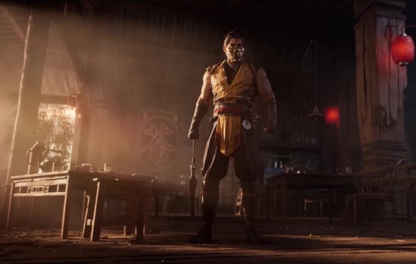 Masked warrior in yellow tunic holding a weapon, standing in a dimly lit tavern.