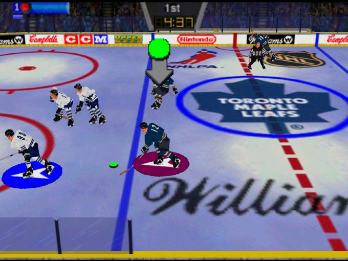 Top-down view of retro hockey video game with players skating near center ice logo