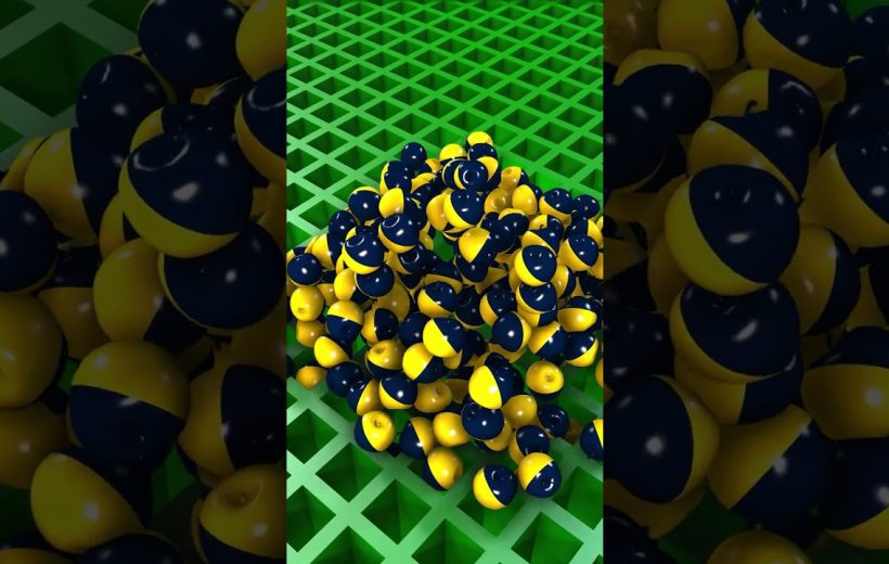 Pile of glossy navy and yellow half-striped spheres on a green lattice surface