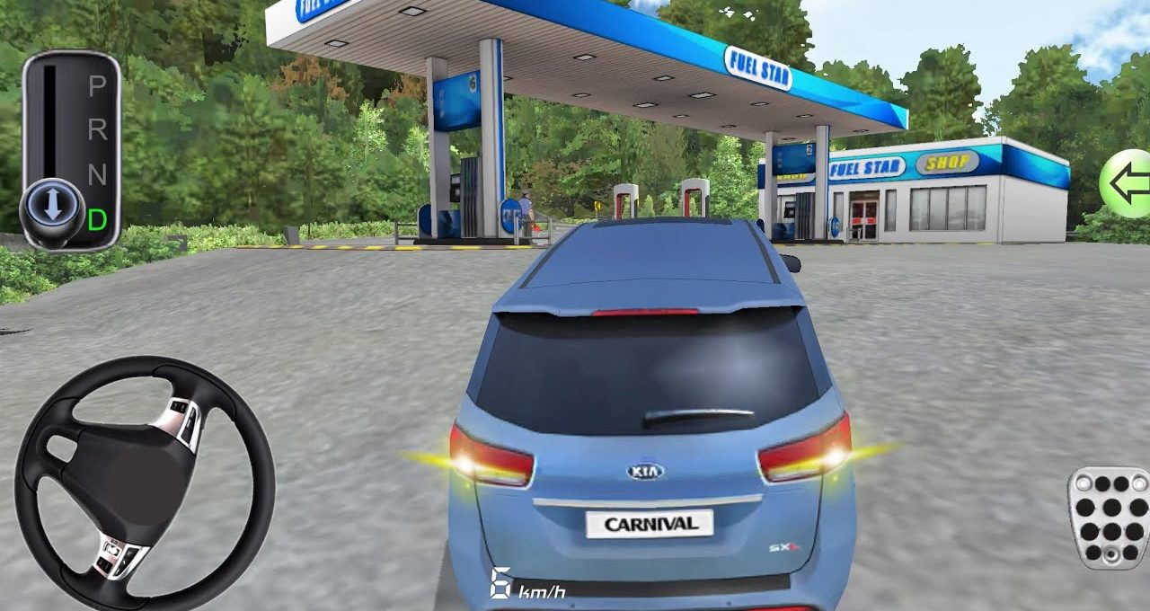 Blue Kia Carnival parked approaching a fuel station canopy with shop in background