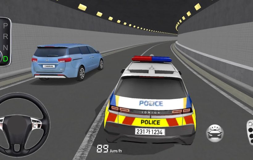 Police car with lights tailing a blue minivan inside a lit road tunnel