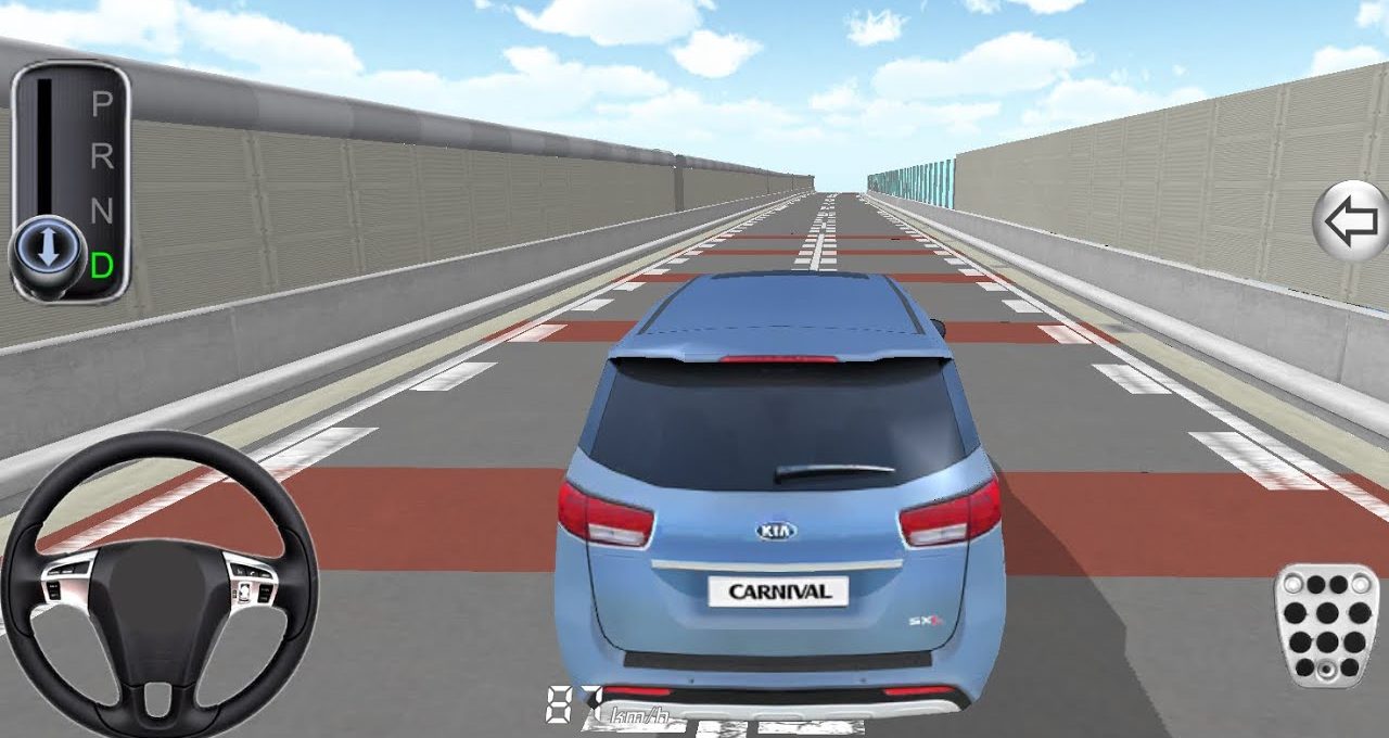 Rear view of a blue Kia Carnival on an empty simulated driving track