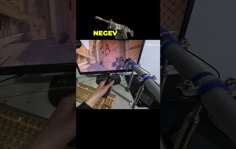 Person using a custom joystick rig to play a first-person shooter on monitor