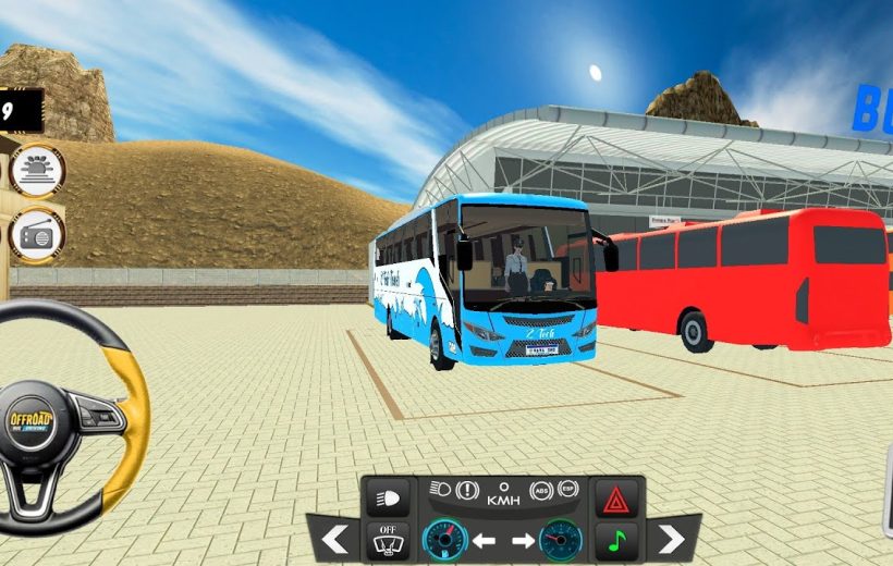 Blue coach bus parked beside a red bus at a modern bus terminal.