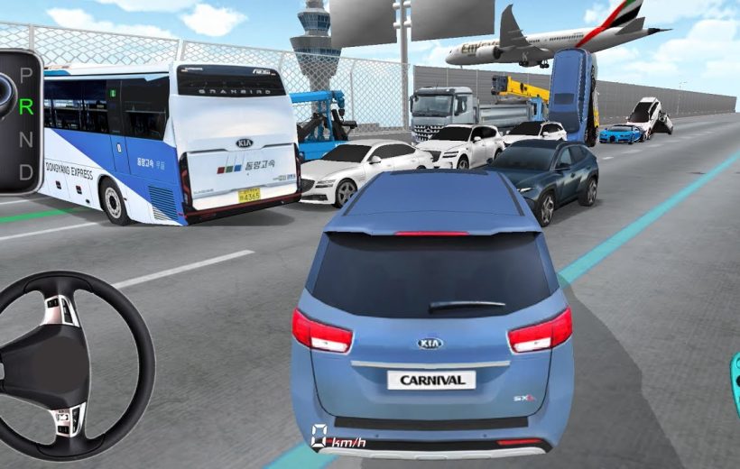 Blue Kia Carnival driving through heavy multi-vehicle traffic near an airport runway.