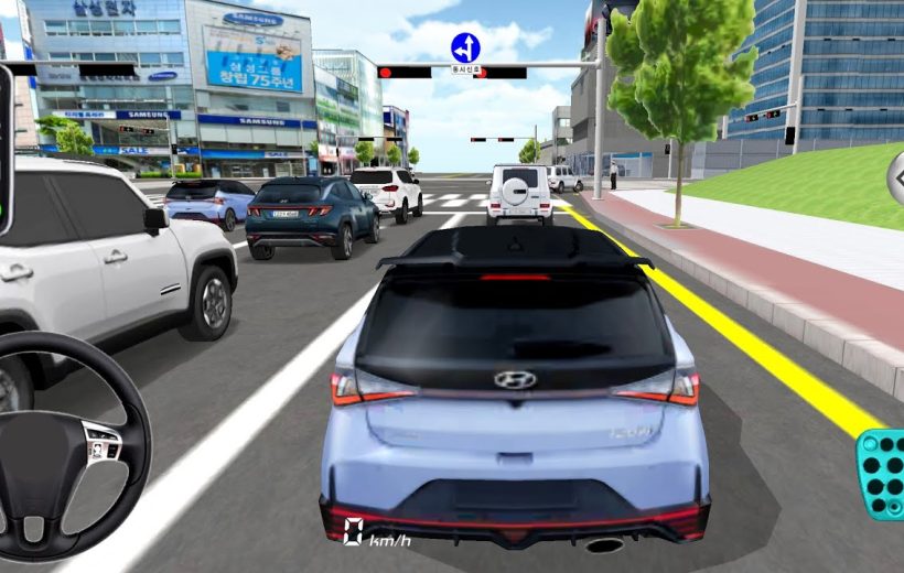 Rear view of a blue Hyundai hatchback driving through a busy city intersection