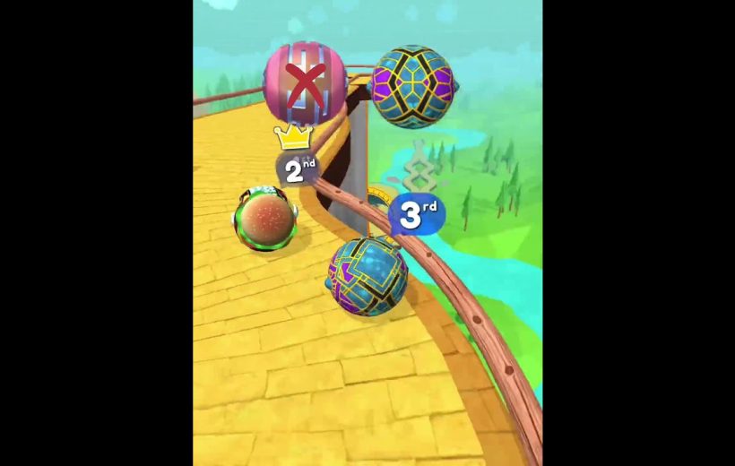 Three colorful rolling balls racing along a curved yellow track with position markers