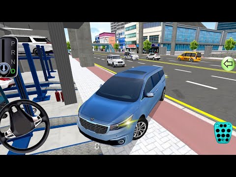 Blue minivan parked at a gas station beside a busy urban street with traffic