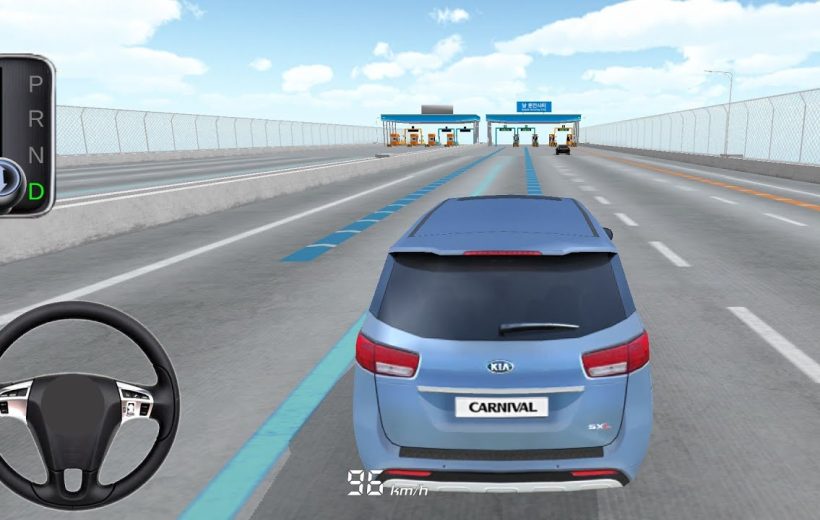 Blue Kia Carnival minivan driving toward toll booths on a multi-lane highway bridge.