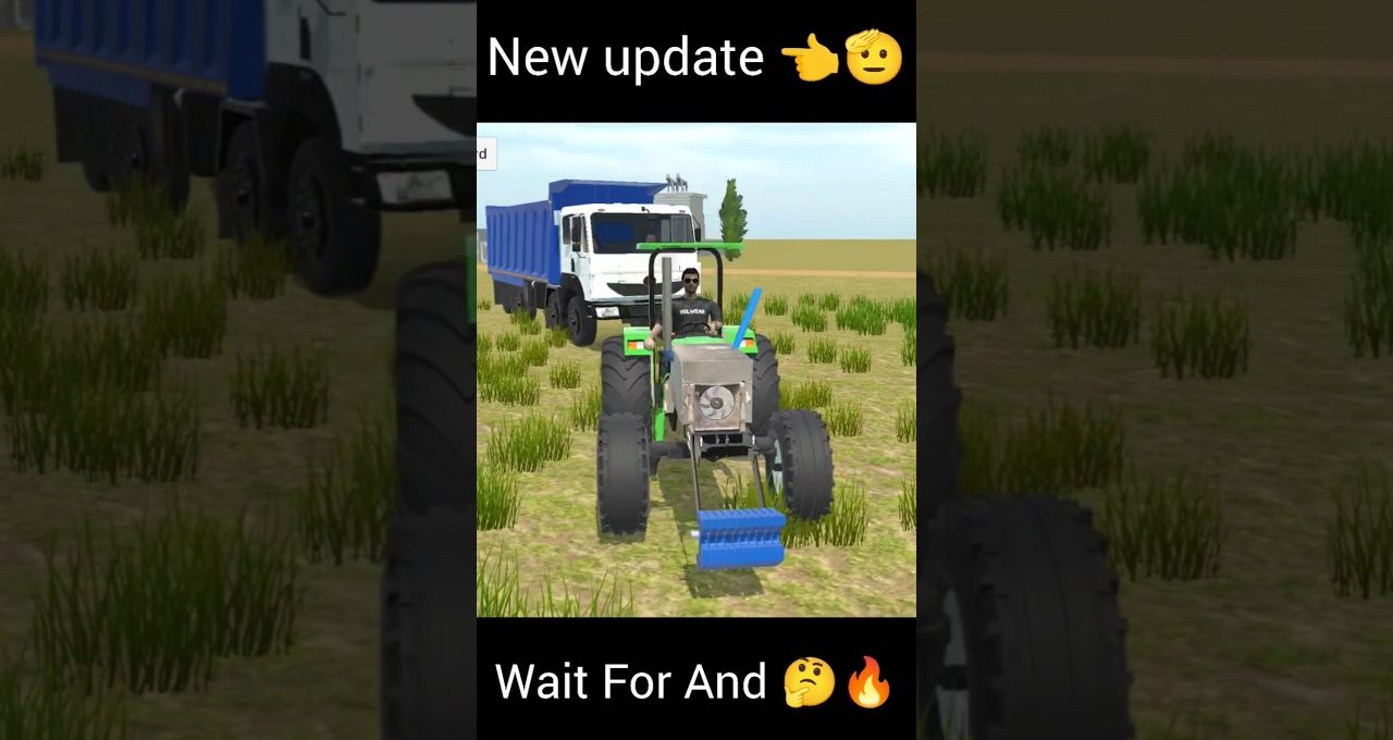 Tractor with front attachment in grassy field, blue dump truck parked behind it