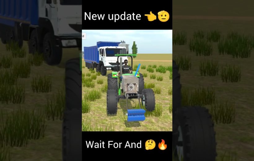 Tractor with front attachment in grassy field, blue dump truck parked behind it