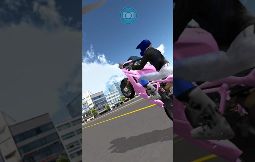 Rider in blue helmet performing a wheelie on a pink sport motorcycle downtown