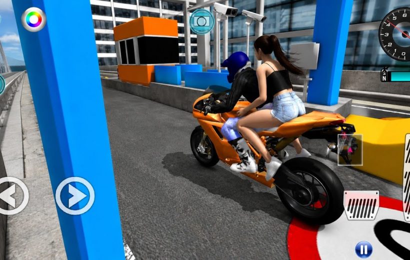 Two people on an orange sport motorcycle passing a toll booth on city bridge.