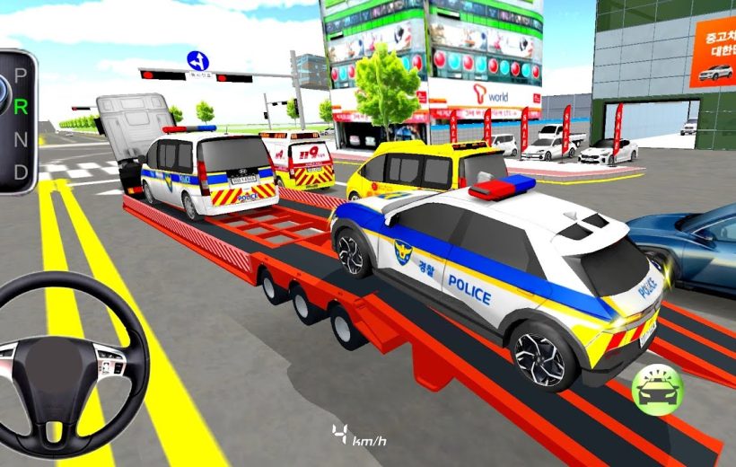 Tow truck loading multiple marked police vehicles on a city street near dealerships