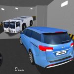 Blue Kia Carnival reversing in underground garage toward approaching white tow tractor