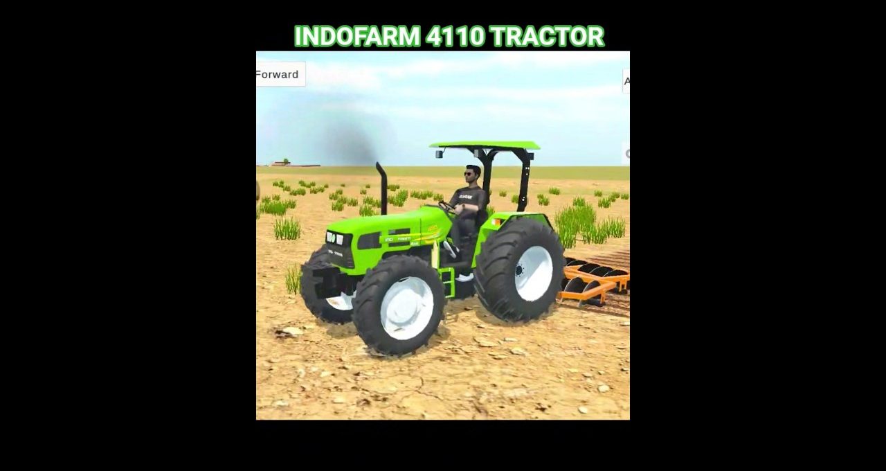 Bright green Indofarm 4110 tractor with driver pulling a disc harrow across dry field