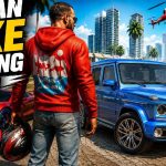 Man in red hoodie holding helmet beside blue SUV and red sports car in cityscape