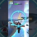 Motorcycle racing game view showing rider jumping through a glowing hoop in snowy landscape
