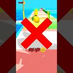 Mobile game scene showing fruit on a colorful obstacle course with a red X.