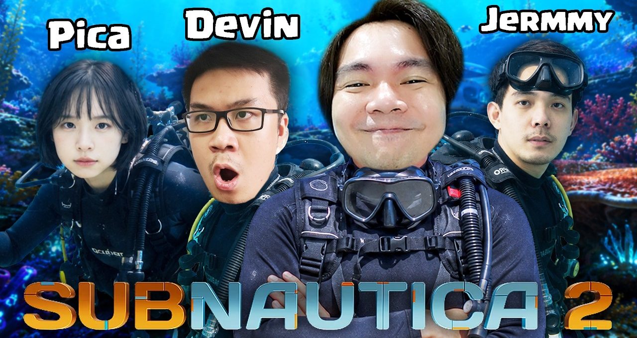 Four divers with scuba gear smiling and posing against an underwater coral background