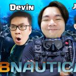 Four divers with scuba gear smiling and posing against an underwater coral background