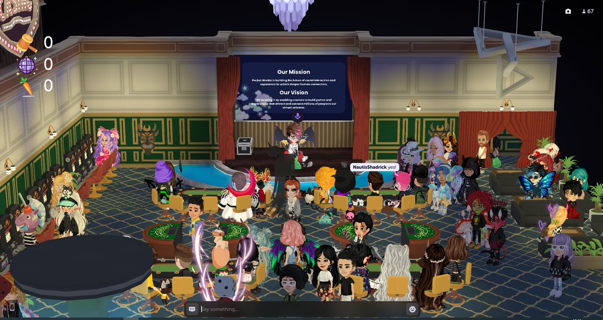 Crowded virtual ballroom with diverse avatars seated around tables watching a stage presentation